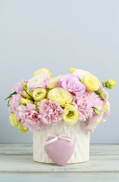 Floral arrangement with pink carnation and yellow eustoma flower
