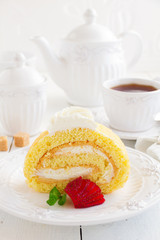 Biscuit roll with strawberry jam, and strawberries.