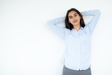 Relaxing Indian woman with hands behind head