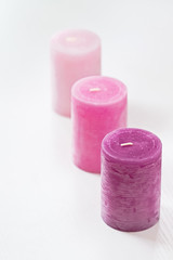 Three pink ombre scented candles on white. Young woman decor ideas. Copyspace