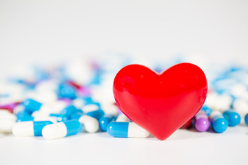 red heart with medical drug