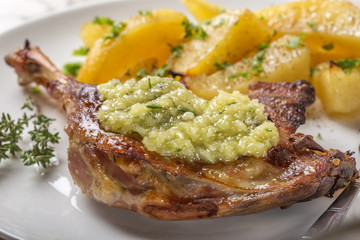 Close up of roast duck with golden potatoes and garlic sauce wit