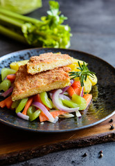 Breaded kale leaves stuffed with cheese, served with steamed vegetable