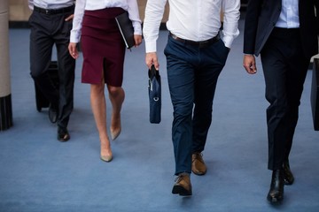 Business executives walking in a conference center lobby