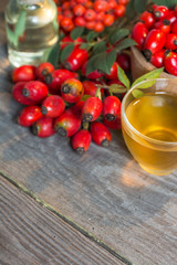 Medicinal plants and herbs composition Pile of dried rose hips and Dog rose, bunch branch Rosehips, types Rosa canina. Herbal tea 