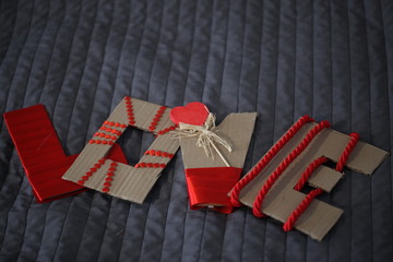 Fototapeta na wymiar love cardboard sign with red ribbons and hearts