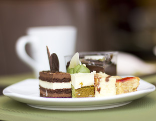 Dessert on a plate. Delicious sweet dessert. Refreshments. Souffle and cakes on a white plate
