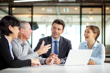 Happy businesspeople having discussing at meeting