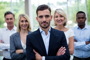 Business executives with arms crossed at conference center