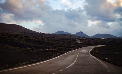 View of Road Along Volcanic Landscape with Mountains