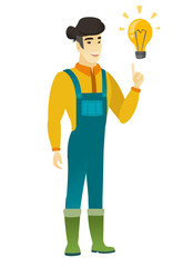 Farmer pointing at bright idea light bulb.