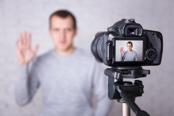 video blogger on screen of modern camera