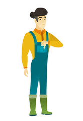 Disappointed asian farmer with thumb down.