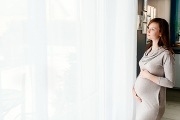 Pregnant woman in grey dress