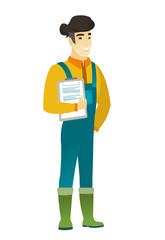 Farmer holding clipboard with documents.