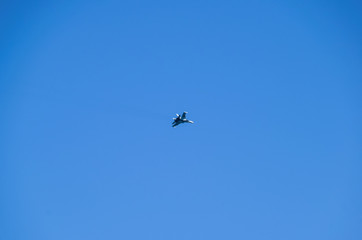 Obraz na płótnie Canvas The fighter in the blue sky. Flying an airplane