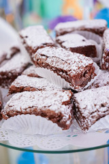 Brownie with glazed sugar in the top, on a white table on a white background.