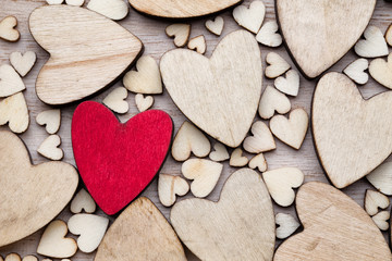 Obraz premium Wooden hearts, one red heart on the heart background.