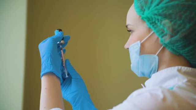 Cosmetology doctor female preparing botox medicine for injection closeup