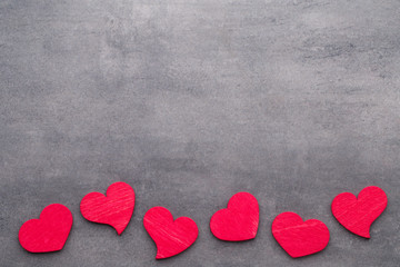 Red hearts on the wooden background.