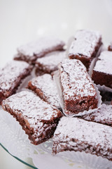 Brownie with glazed sugar in the top, on a white table on a white background.