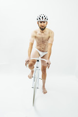 Nake man with white bicycle