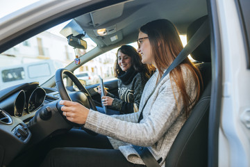 Two women riding a car