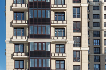 Fototapeta na wymiar Facade of modern apartment flat house with balconies and windows. 