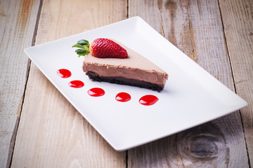 Chocolate cake slice with strawberry and topping