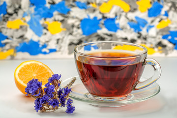 tea in the glass cup with lemon and flower