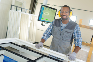 Male worker manufacturing windows - obrazy, fototapety, plakaty