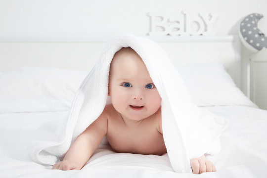 Cute baby lying on bed