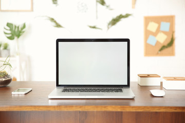 Fototapeta premium Modern laptop on wooden desk
