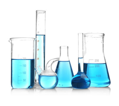 Laboratory glassware with blue samples on white background