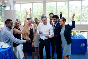 Happy business executives looking at report