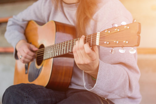 Musician playing guitar. Lens flare