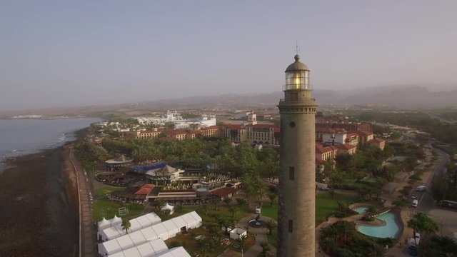 Aerial panorama of tourist town and resort areas on Gran Canaria coast, Maspalomas Lighthouse in the foreground