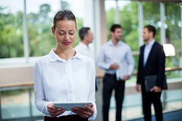 Female business executives using digital tablet