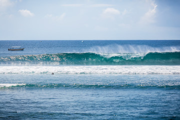 Blue waves in Bali. Tropical surfing. Relax. Sunny day in paradise