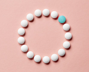 white pills on pink background