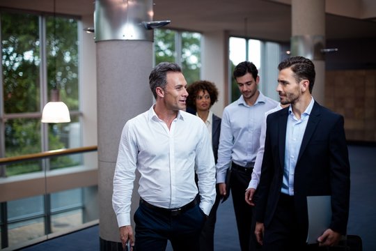 Business executives walking in a conference center lobby