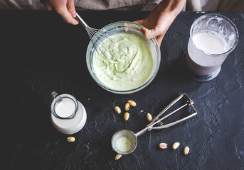 organic ice cream homemade process on dark background with hands