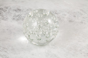 Glass ball on textured background