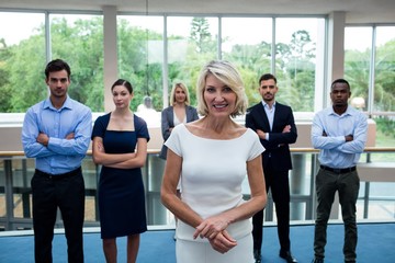 Naklejka premium Business executives with arms crossed at conference center