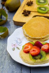 Kiwi fruit cut in slices on wooden cutting board