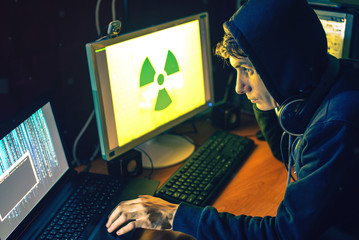 young hacker in the dark infect computers and systems