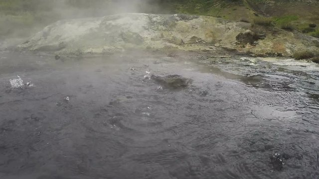 Dachnye Hot Springs located at foot of active Mutnovsky Volcano in Kamchatka Peninsula: boiling water in natural volcanic hot springs.