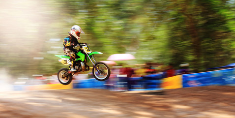 Obraz premium Motion blur of motocross Bike Jump,camera panning technique.