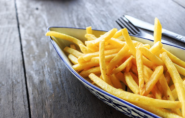 french fries dish or fried potato on the table with film colors tone. soft-focus in the background and over light