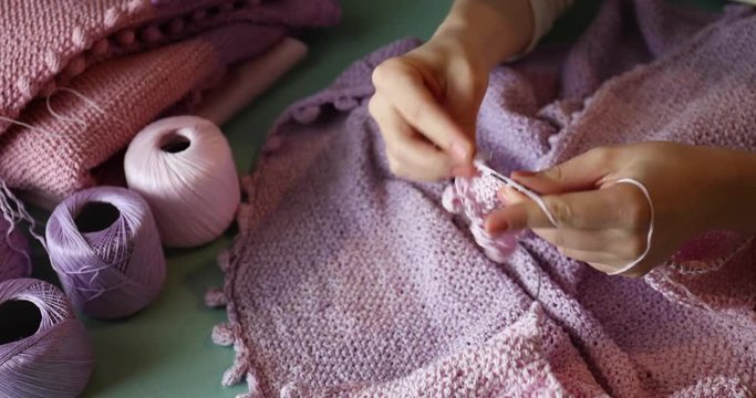 Female hand knitting needles
